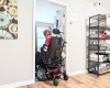 An individual in a wheelchair positioned in a doorway.