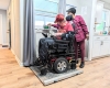 A person in a wheelchair sitting in a doorway.